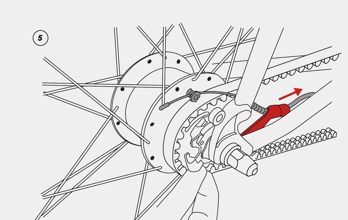 Pulling the Shimano Alfine shift cable out of its holder.