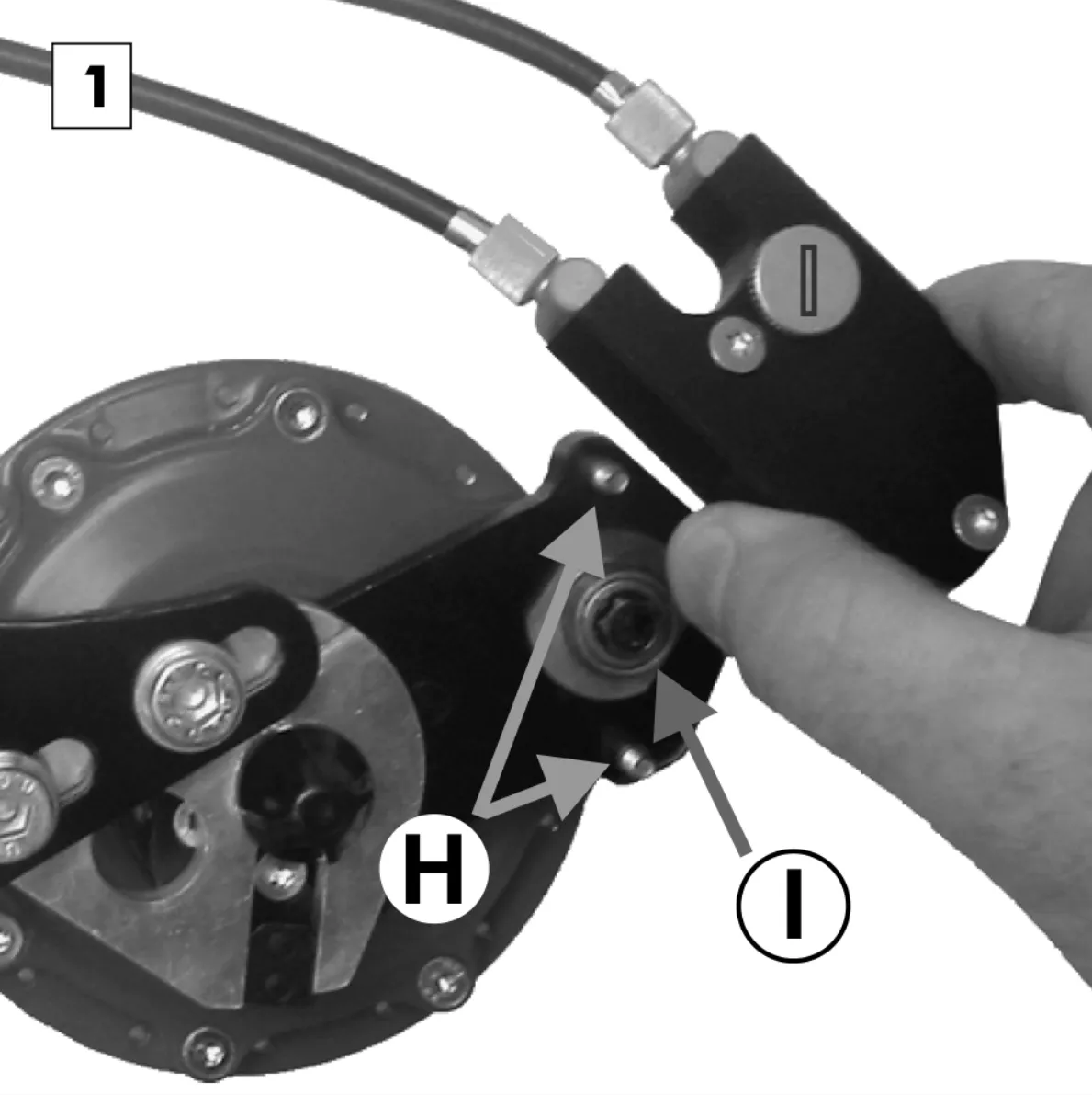 Sliding the cable box E onto the guide pins H until the hexagon I of the shift shaft engages.
